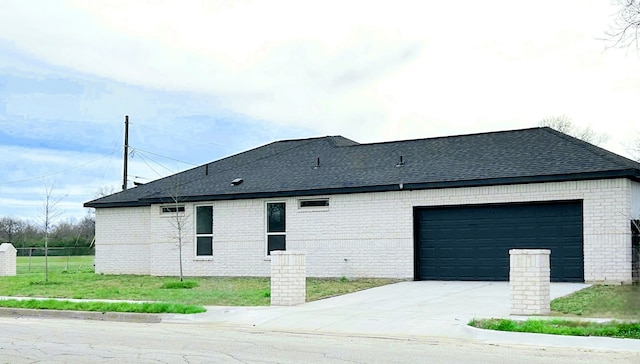 5147 Chapman St, Fort Worth, TX 76105 - view of side of property featuring brick siding, a garage, roof with shingles, and concrete driveway