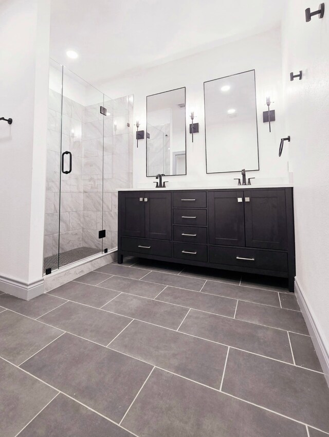 5147 Chapman St, Fort Worth, TX 76105 - bathroom with a stall shower, baseboards, double vanity, and tile patterned flooring