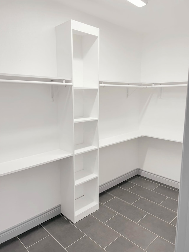 5147 Chapman St, Fort Worth, TX 76105 - walk in closet featuring dark tile patterned flooring