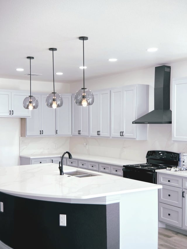 5147 Chapman St, Fort Worth, TX 76105 - kitchen featuring wall chimney exhaust hood, electric range, a sink, light stone counters, and a center island with sink