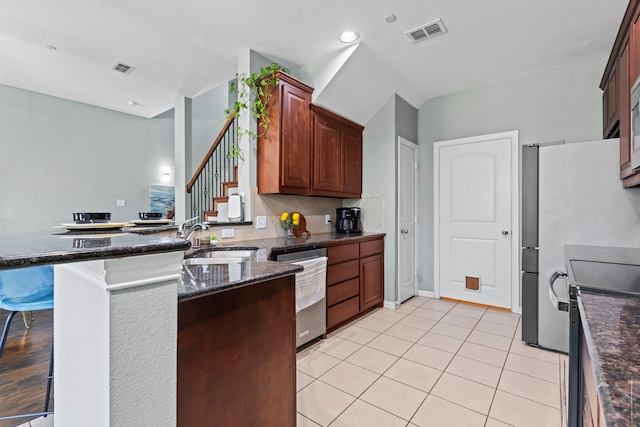 kitchen featuring visible vents, backsplash, electric range, stainless steel dishwasher, and a sink