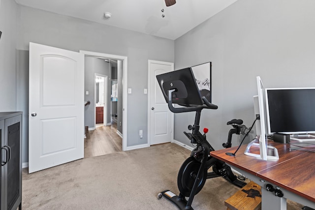 exercise room with carpet floors, baseboards, and a ceiling fan