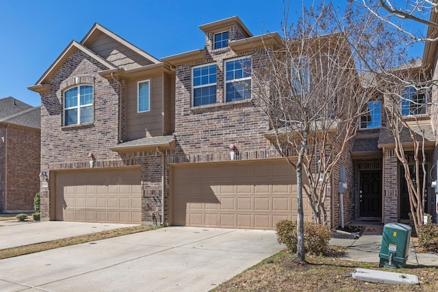 townhome / multi-family property featuring concrete driveway, brick siding, and an attached garage