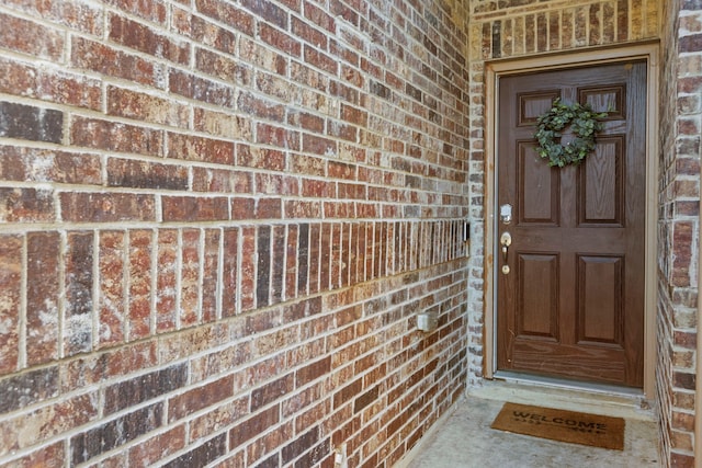 property entrance with brick siding