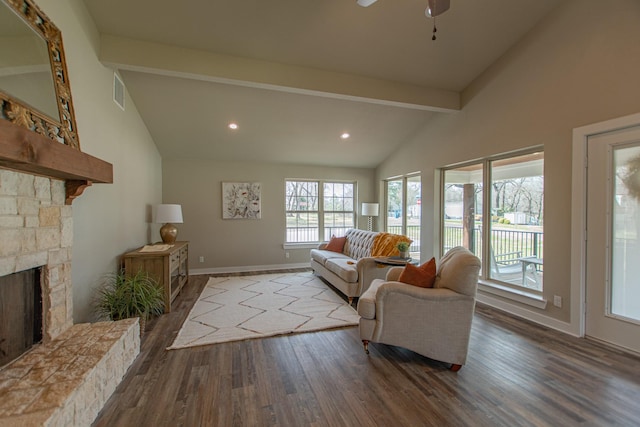 living area featuring a fireplace, wood finished floors, beam ceiling, and baseboards