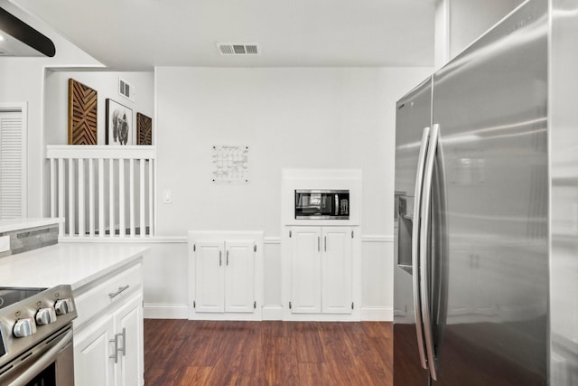 kitchen with stainless steel appliances, light countertops, visible vents, and dark wood-type flooring