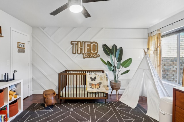 bedroom featuring a decorative wall and wood finished floors