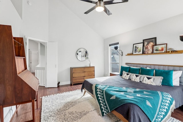 bedroom featuring high vaulted ceiling, wood finished floors, a ceiling fan, and baseboards