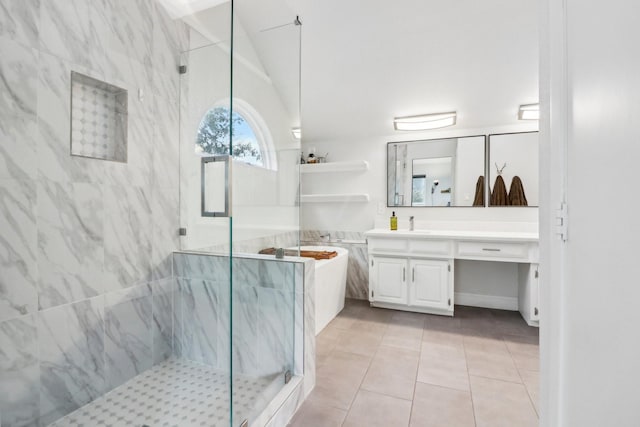 full bathroom with a soaking tub, vanity, a marble finish shower, and tile patterned floors