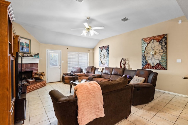 living area featuring visible vents, a ceiling fan, a fireplace, light tile patterned floors, and vaulted ceiling