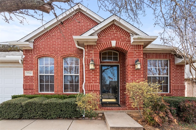 exterior space with brick siding and an attached garage