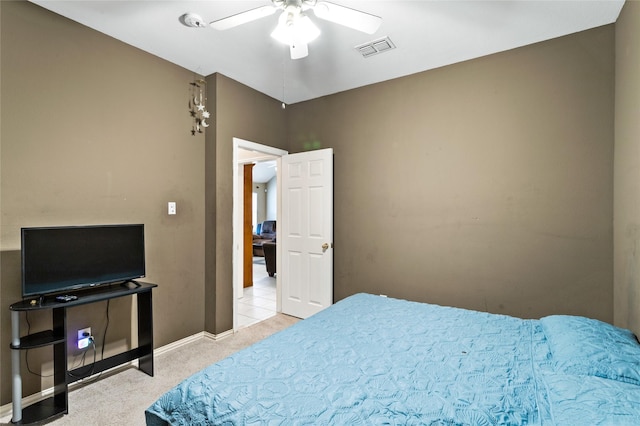 bedroom featuring visible vents, light colored carpet, baseboards, and ceiling fan