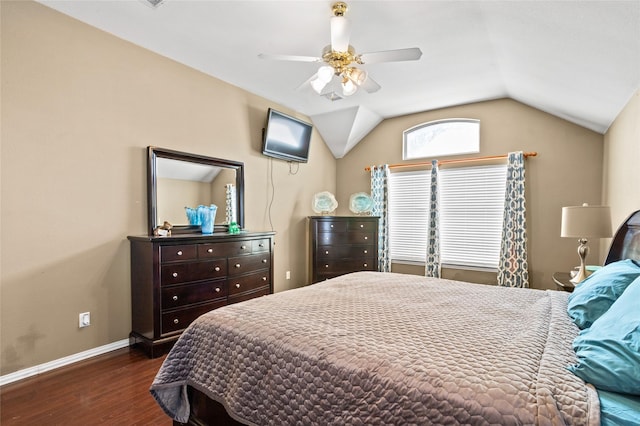 bedroom featuring lofted ceiling, wood finished floors, baseboards, and ceiling fan