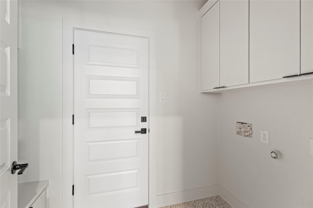 clothes washing area featuring baseboards