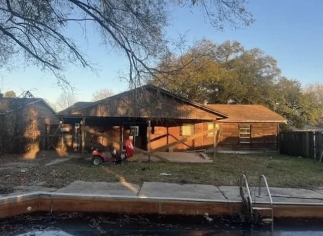 rear view of property with fence