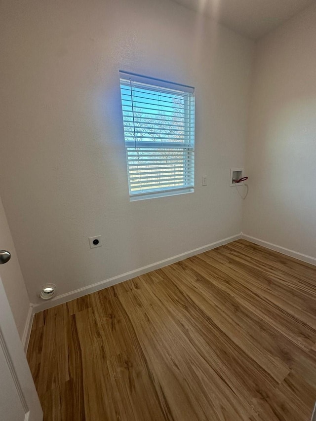 unfurnished room featuring wood finished floors and baseboards