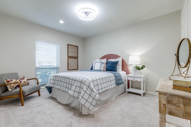 bedroom with light carpet and baseboards