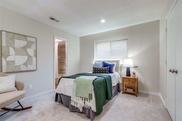 carpeted bedroom featuring recessed lighting, baseboards, visible vents, and ensuite bathroom