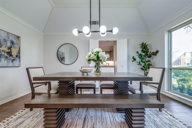 dining area featuring lofted ceiling, crown molding, visible vents, and wood finished floors