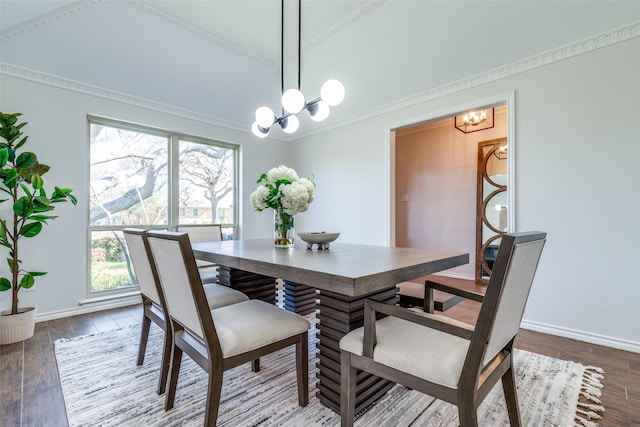 dining room with an inviting chandelier, baseboards, and wood finished floors