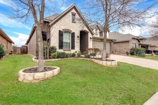 view of front of property featuring driveway, stone siding, an attached garage, a front lawn, and brick siding