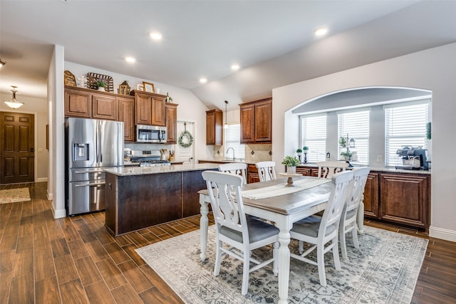 dining room with lofted ceiling, dark wood-type flooring, baseboards, and recessed lighting