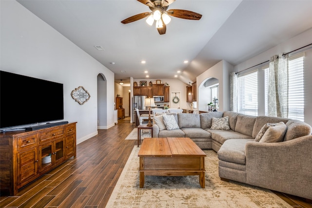 living room with arched walkways, baseboards, dark wood-style floors, ceiling fan, and recessed lighting