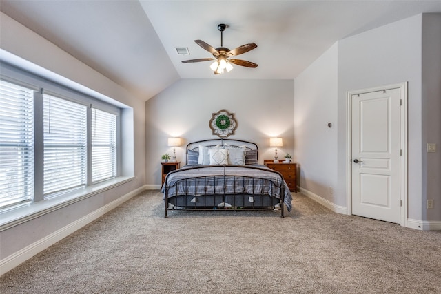 carpeted bedroom with a ceiling fan, visible vents, vaulted ceiling, and baseboards