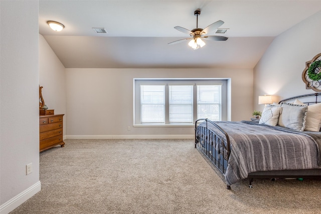 bedroom with vaulted ceiling, carpet flooring, visible vents, and baseboards