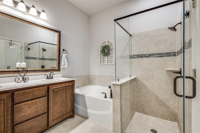 full bath with a stall shower, tile patterned flooring, a garden tub, and vanity