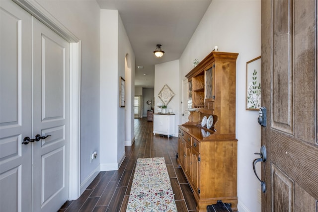 hall with wood tiled floor and baseboards