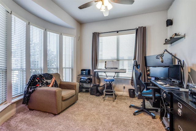 carpeted office with ceiling fan and baseboards