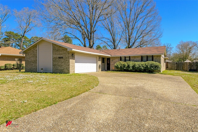 view of front of house featuring an attached garage, brick siding, concrete driveway, and a front yard