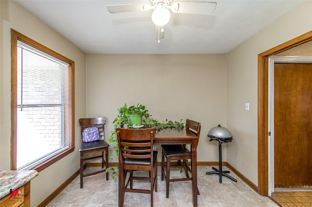 dining room featuring a ceiling fan and baseboards