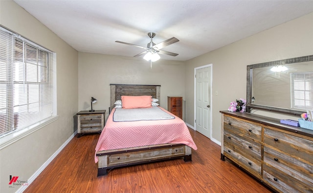 bedroom with wood finished floors, a ceiling fan, and baseboards