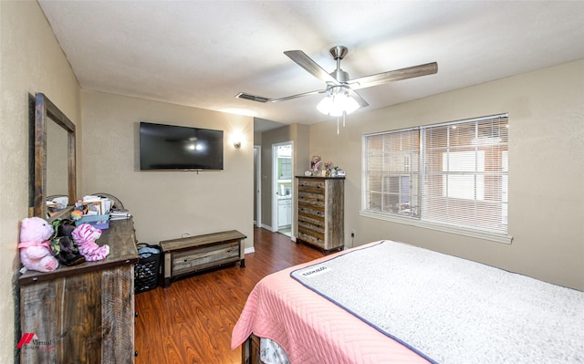 bedroom featuring ceiling fan, multiple windows, wood finished floors, and visible vents