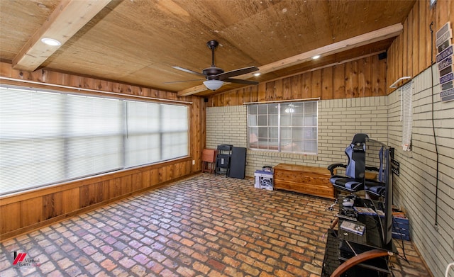 unfurnished sunroom with a ceiling fan, wooden ceiling, and vaulted ceiling with beams