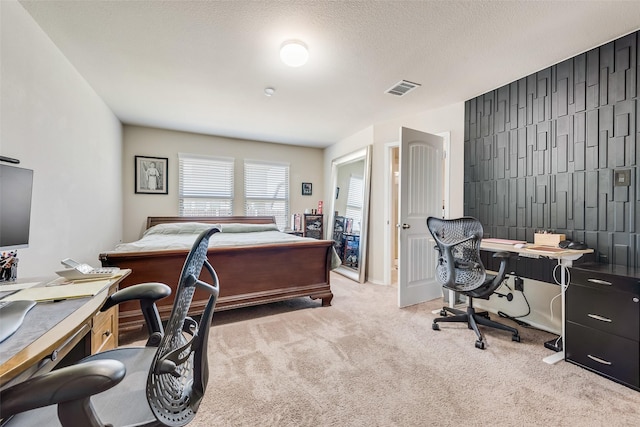 carpeted bedroom with visible vents and a textured ceiling