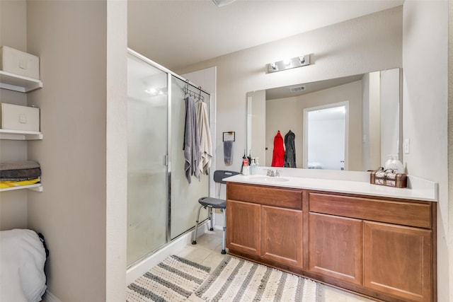 full bathroom featuring a stall shower, tile patterned flooring, visible vents, and vanity