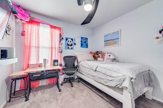 carpeted bedroom featuring ceiling fan and baseboards