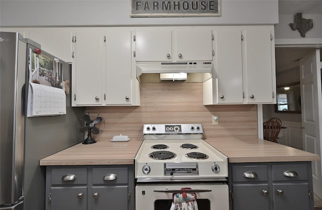 kitchen with under cabinet range hood, white cabinets, light countertops, freestanding refrigerator, and white electric range oven