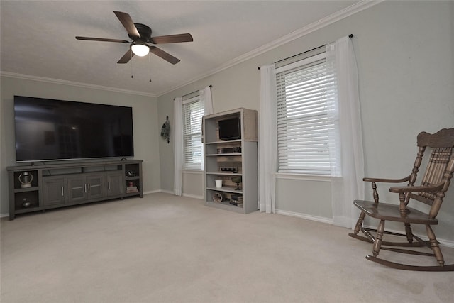 living area featuring a ceiling fan, light carpet, crown molding, and baseboards