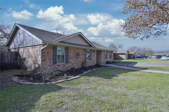 ranch-style house with fence, a front lawn, board and batten siding, and brick siding