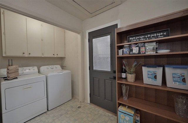 laundry room featuring washing machine and dryer, cabinet space, and light floors