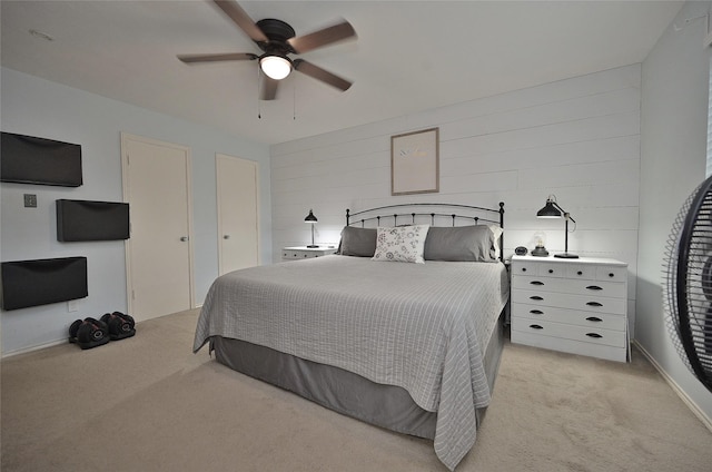 bedroom featuring a ceiling fan and light colored carpet