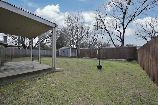 view of yard featuring a fenced backyard, a shed, and an outbuilding