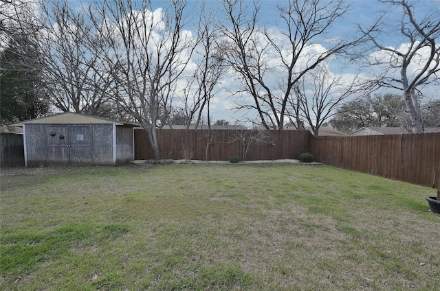 view of yard featuring a fenced backyard, a storage unit, and an outdoor structure