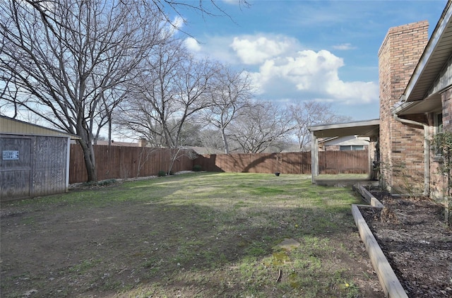 view of yard with a shed, an outdoor structure, and a fenced backyard