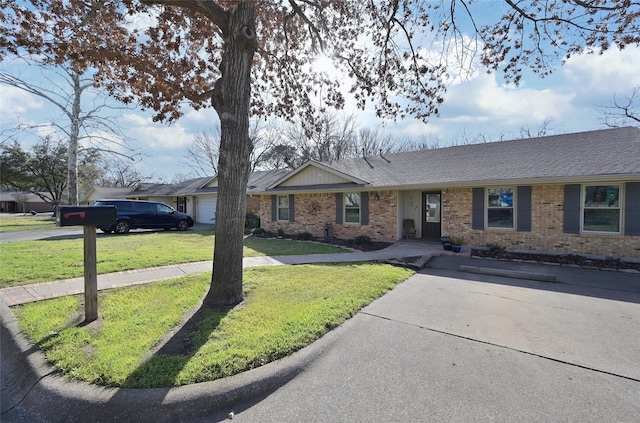 single story home featuring brick siding, roof with shingles, and a front yard