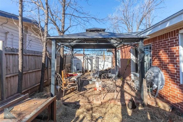 exterior space featuring a fenced backyard and a gazebo